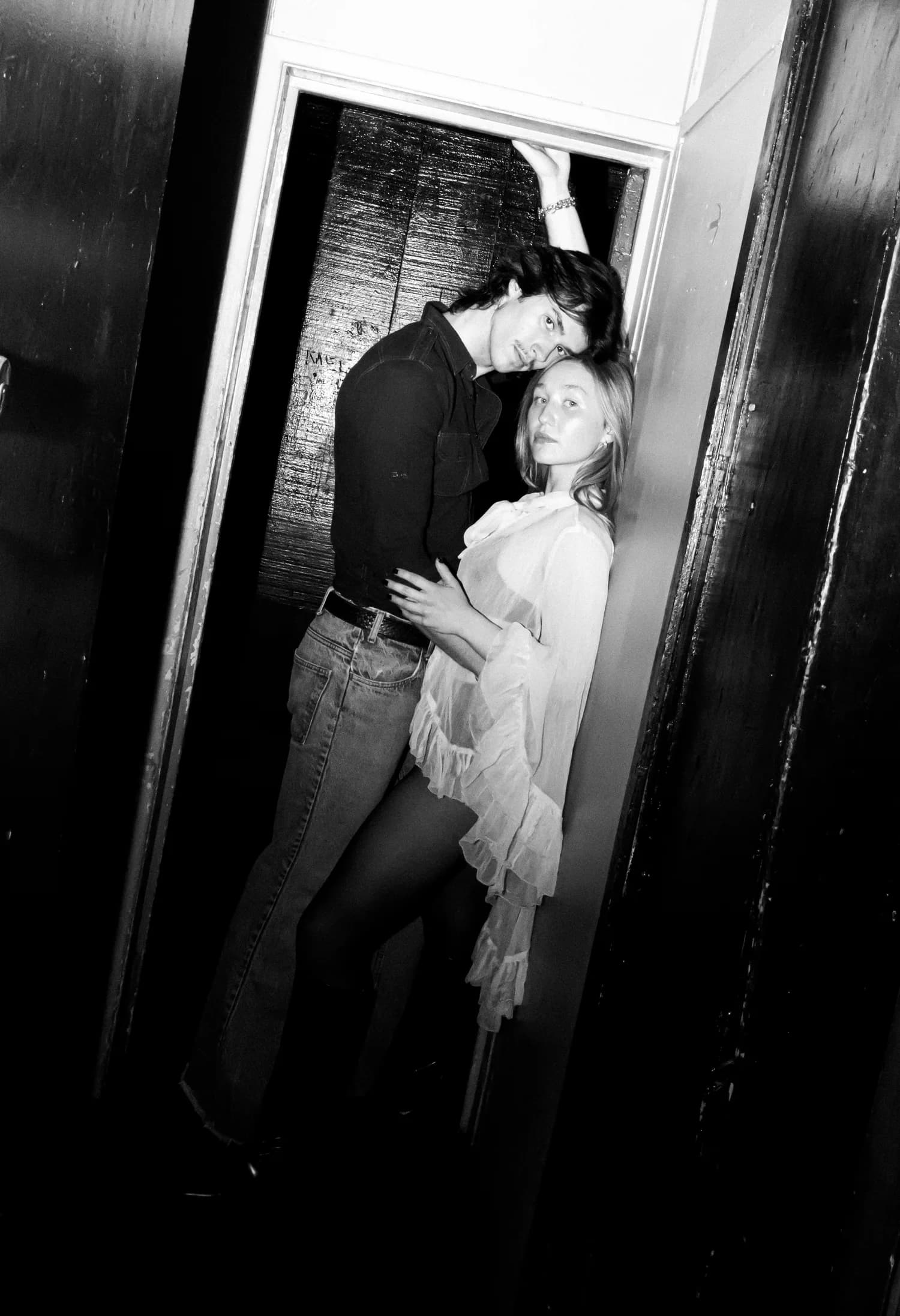 Glass Kinsman backstage in a dramatic black-and-white portrait.