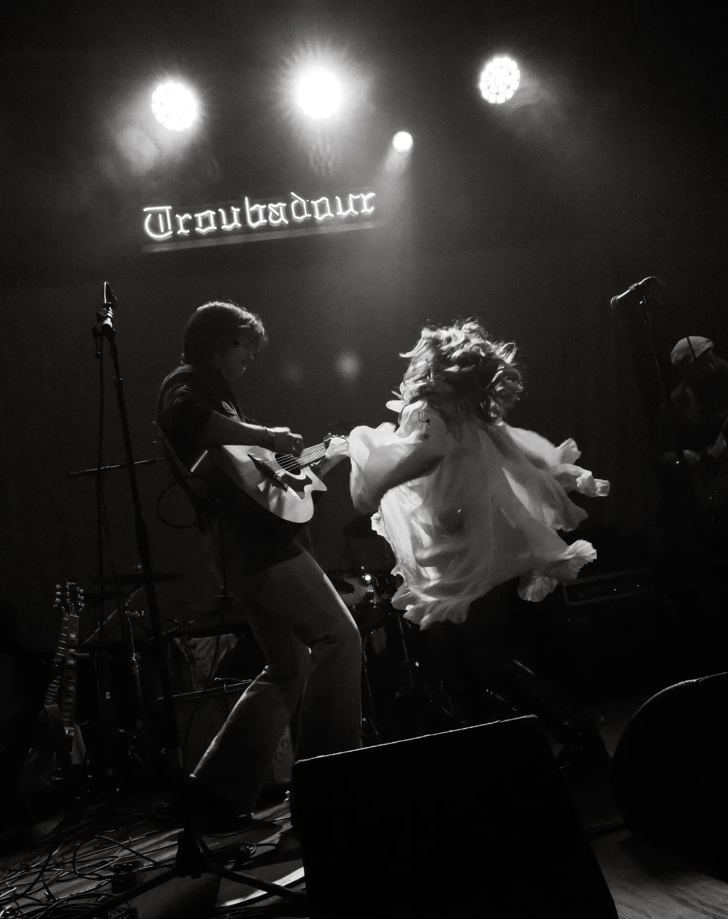 Glass Kinsman performing mid-song under stage lights.